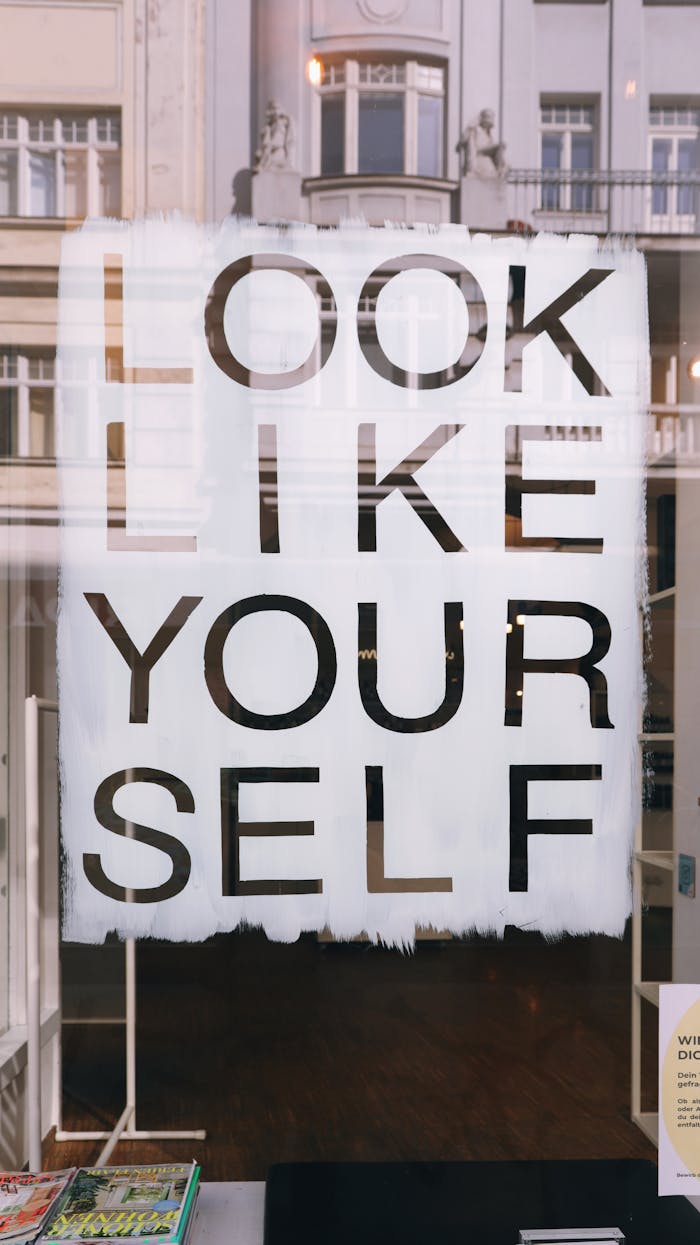 A motivational shop window sign saying 'Look Like Yourself' in Vienna, Austria.